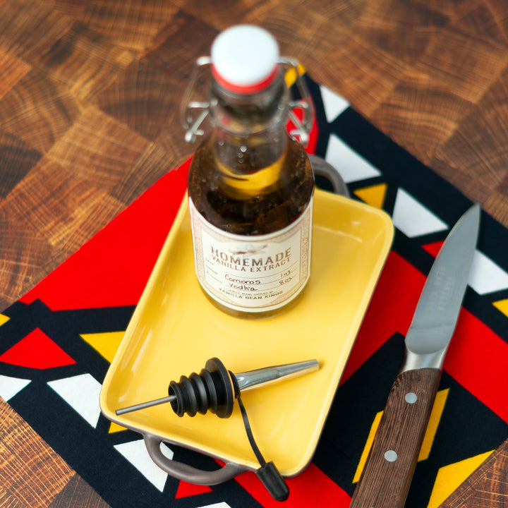 Comoros vanilla beans extracting in glass bottle