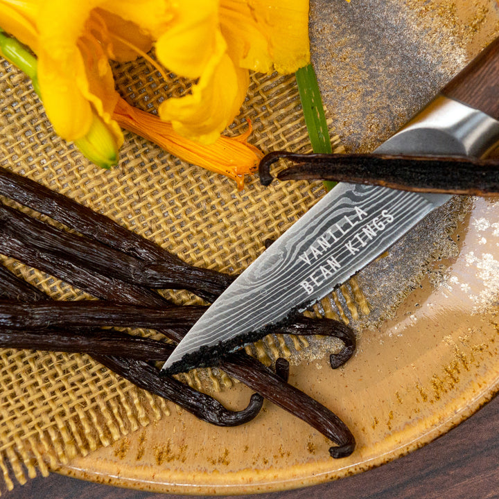 rwandan vanilla beans with 1 split and caviar displayed on knife