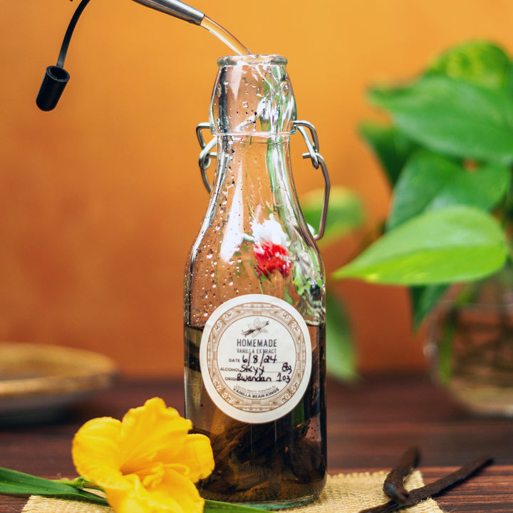 rwandan vanilla beans extracting in glass bottle