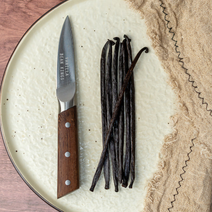 sumatra vanilla beans next to a knife on a plate