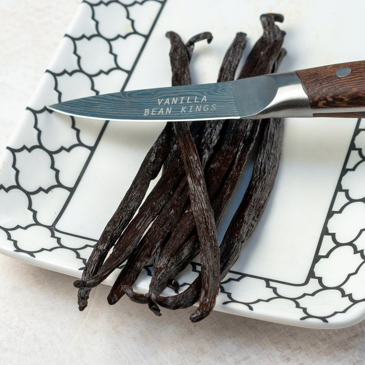 tanzania vanilla beans displayed on plate with knife