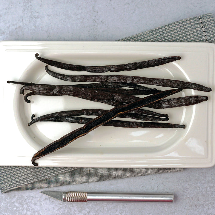 burundi vanilla beans on a dish with 1 split showing caviar