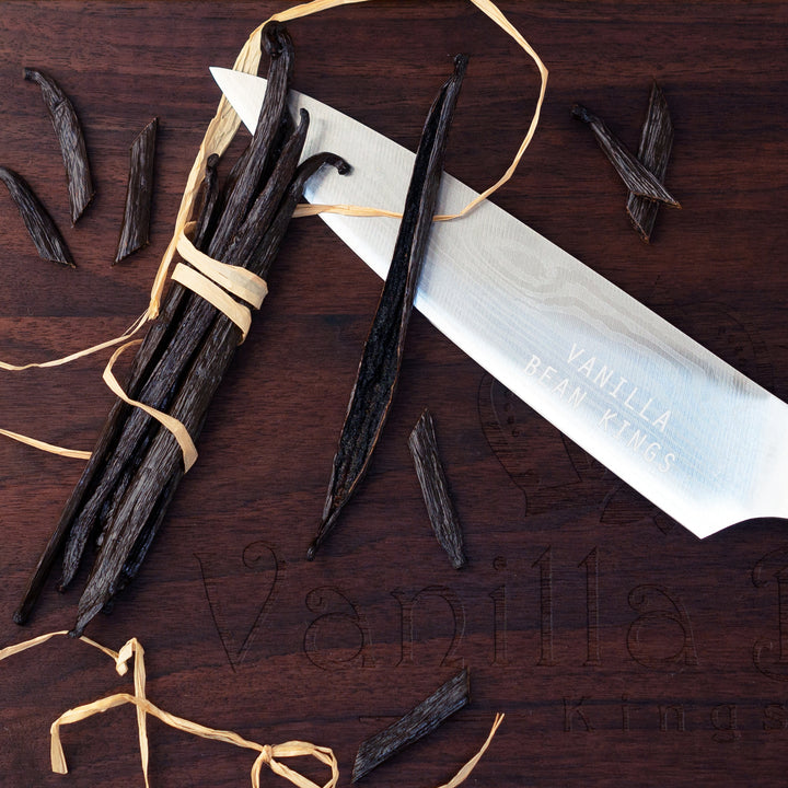 ecuador vanilla beans cut and with 1 split bean showing caviar laying on knife