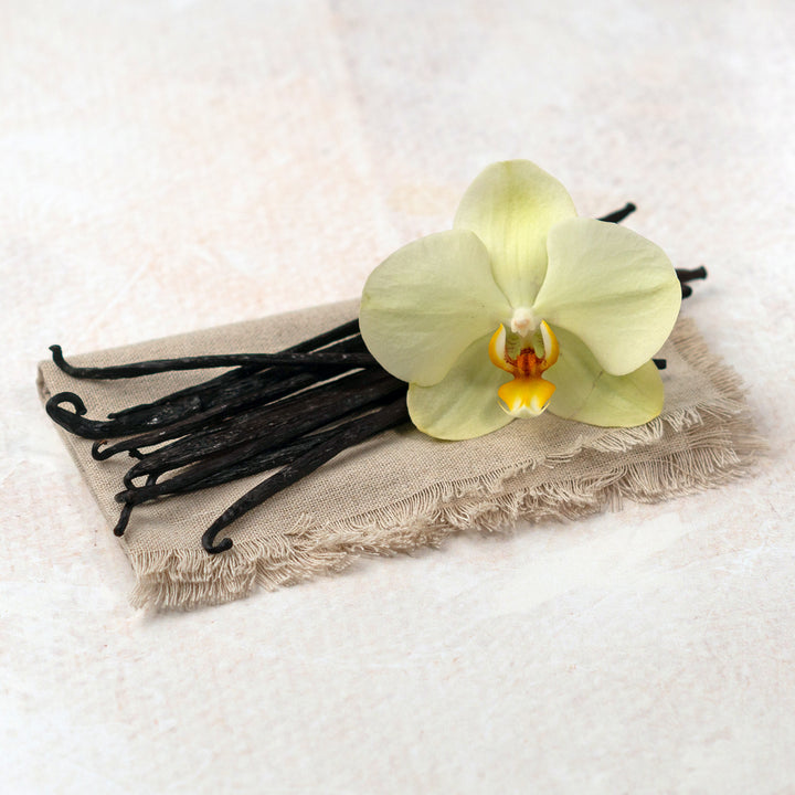 hawaiin vanilla beans with flower laying on cloth