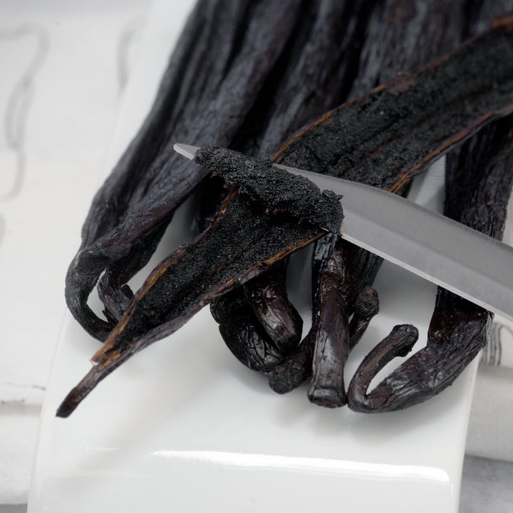 pompano vanilla beans with one bean split showing caviar on knife