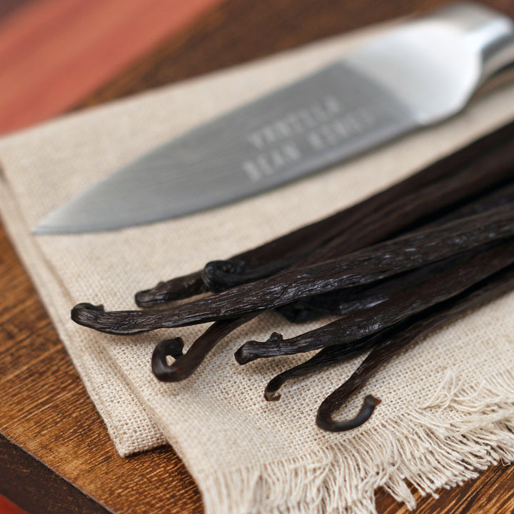 papua new guinea vanilla bean close up by knife