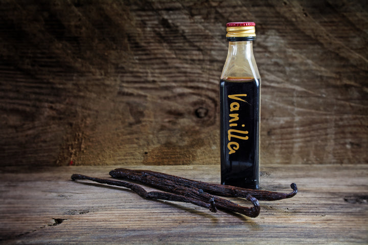 homemade vanilla extract on wood backdrop